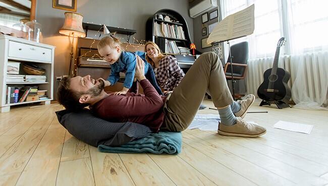 Happy family on hardwood flooring | The Floor Store VA